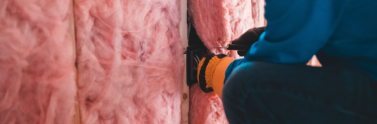 person working on insulation panel and foam