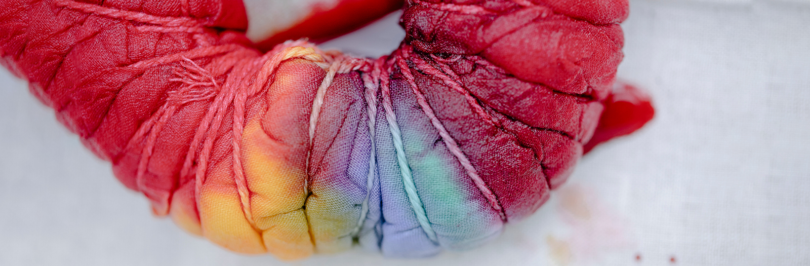 Multicolored dyed fabric tied with ropes
